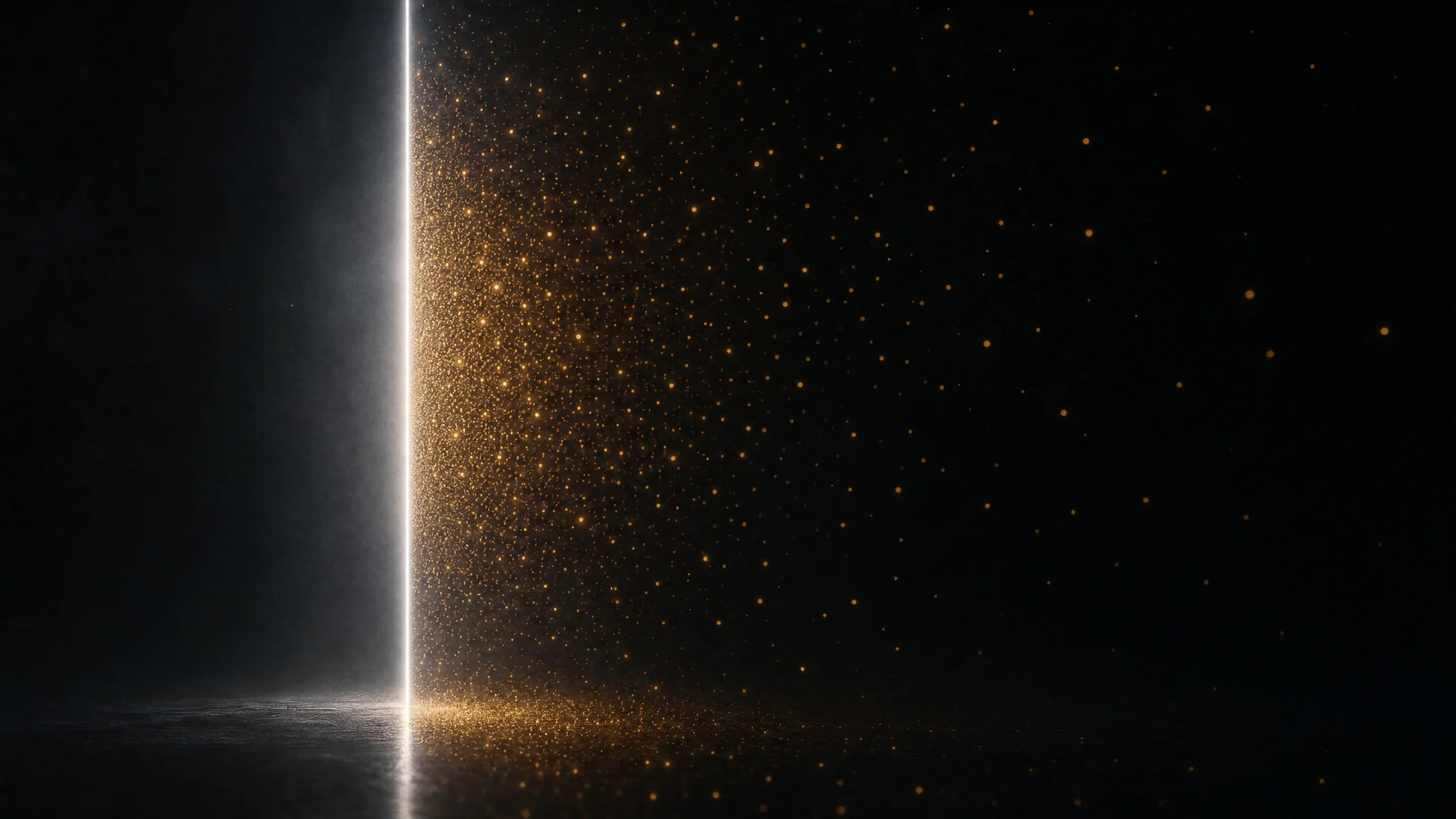 A white vertical line cuts through near-darkness as amber-gold particles cluster densely at its edge and thin across the black field to the right